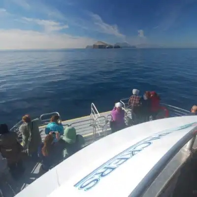 a group of people in a boat on a body of water