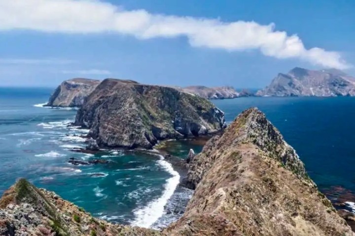 a rocky island in the middle of a body of water