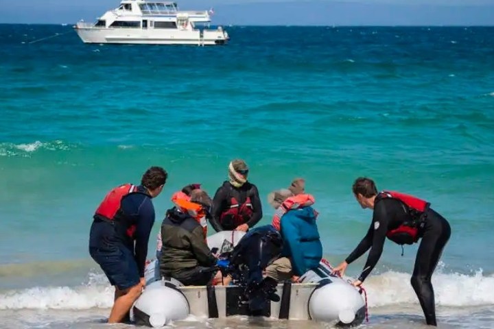 a group of people on a boat in the ocean