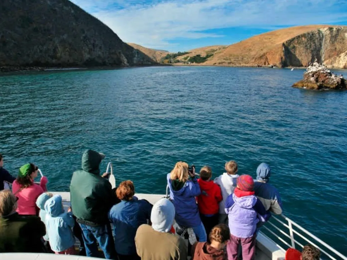 a group of people in front of a body of water