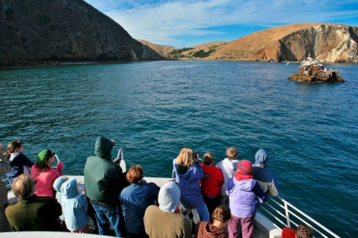 a group of people in front of a body of water