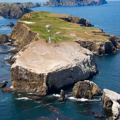 a rocky island in the middle of a body of water