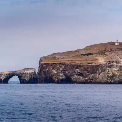a large body of water with a mountain in the background