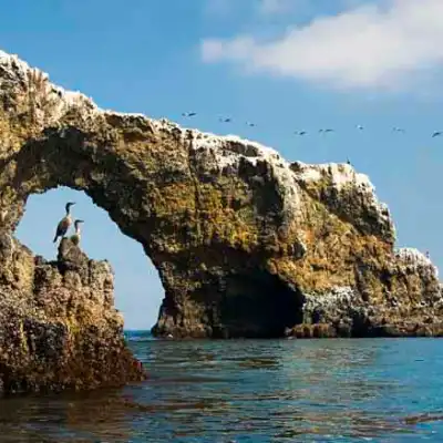a large body of water with a mountain in the background