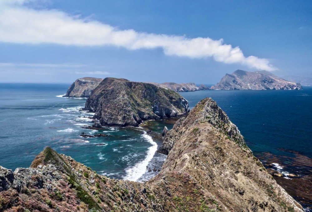 a rocky island in the middle of a body of water