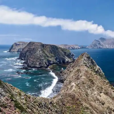 a rocky island in the middle of a body of water