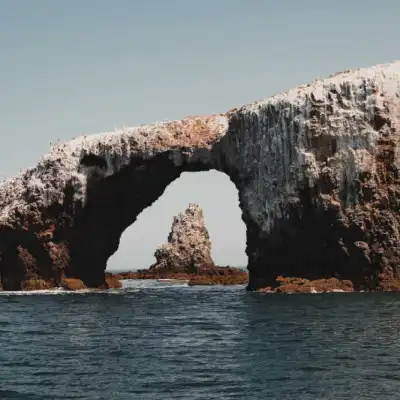 a view of a large rock next to water