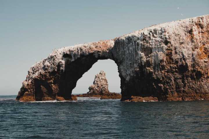 a view of a large rock next to water