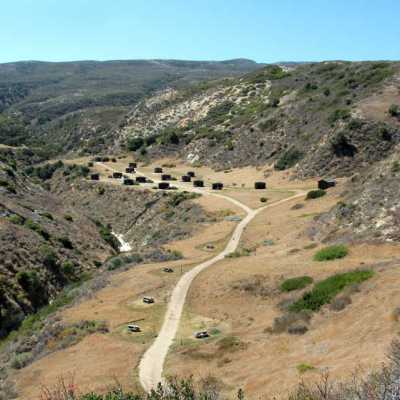 a tall rocky mountains on a dirt road