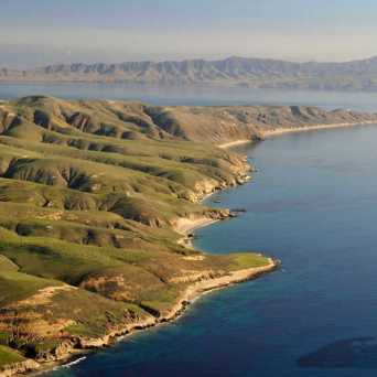 a large body of water with a mountain in the background