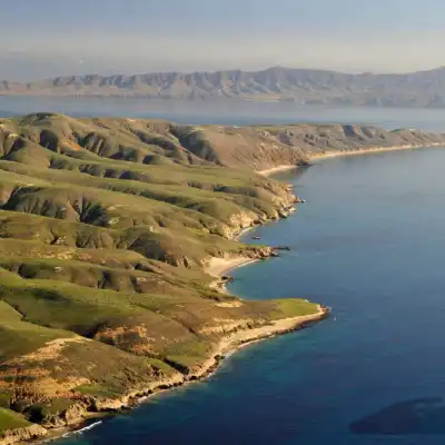 a large body of water with a mountain in the background