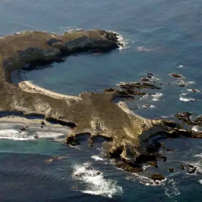 a body of water next to the rock