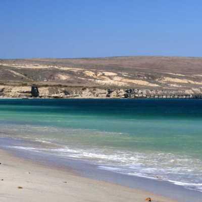 a group of people on a beach near a body of water