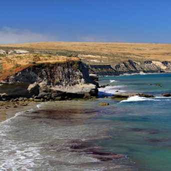 a body of water with a mountain in the background