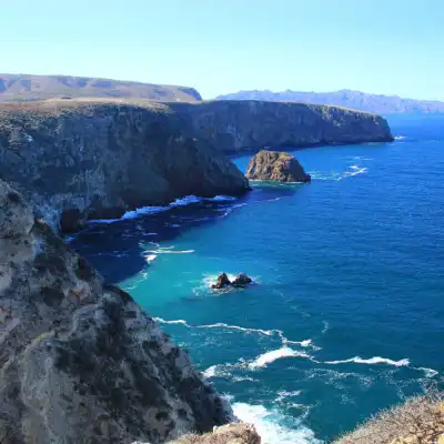 a body of water with a mountain in the background