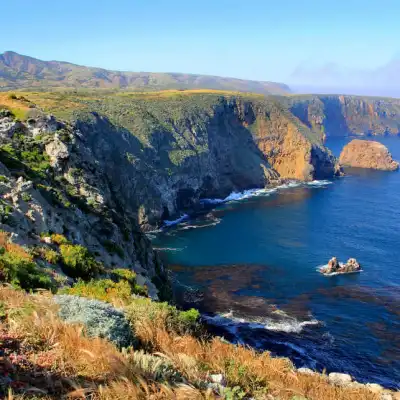 a body of water with a mountain in the background