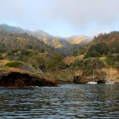 a large body of water with a mountain in the background
