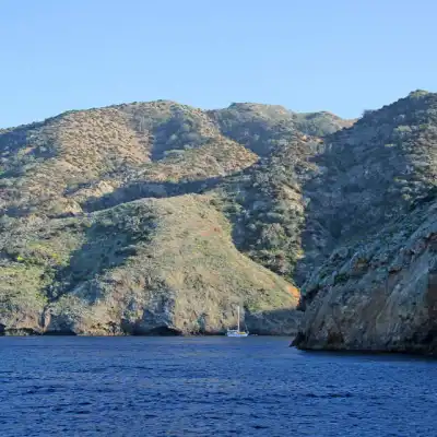 a large body of water with a mountain in the background