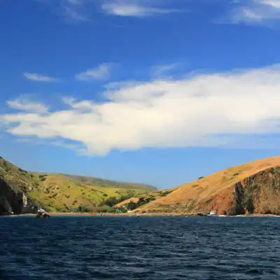 a large body of water with a mountain in the background