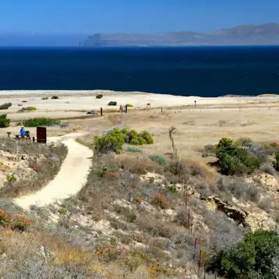 a body of water with a mountain in the background