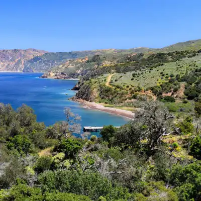 a large body of water with a mountain in the background