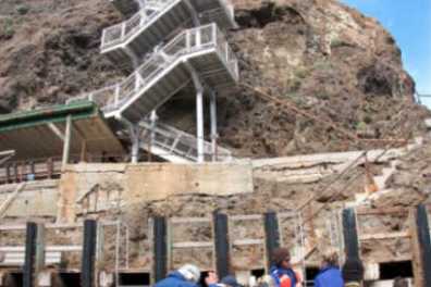 a group of people standing in front of a mountain