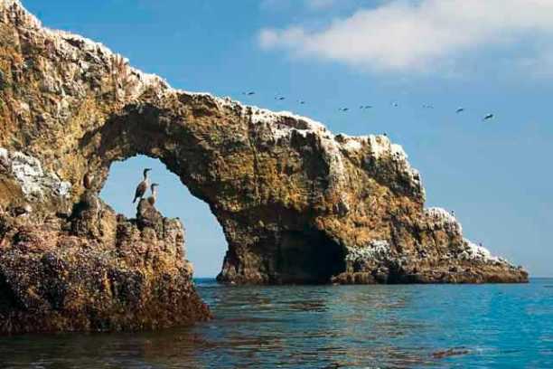 a large body of water with a mountain in the background