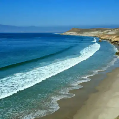 a rocky beach next to a body of water