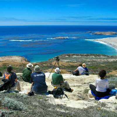 a group of people sitting at a beach