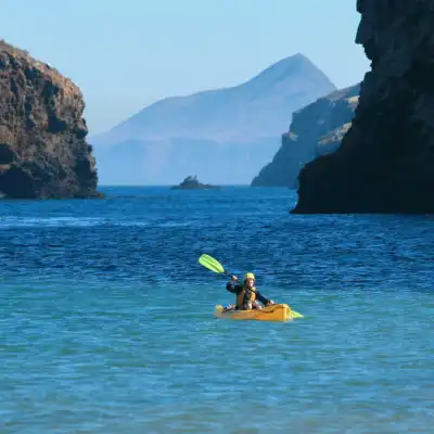 a body of water with a mountain in the background