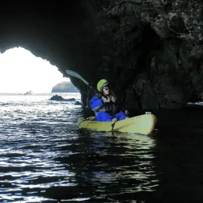 a man riding on the back of a boat in the water