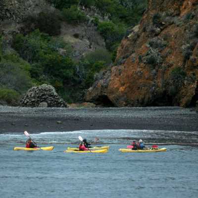 a group of people in a small boat in a body of water