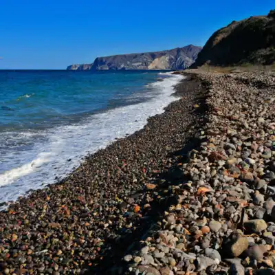 a rocky beach next to a body of water