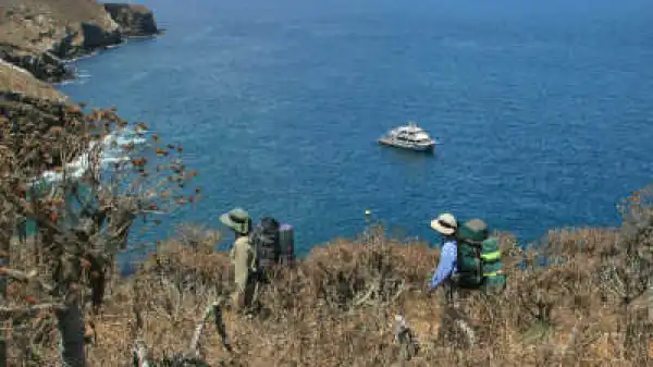 a group of people standing next to a body of water