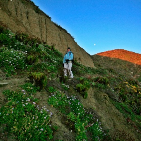 a man standing on a rocky hill