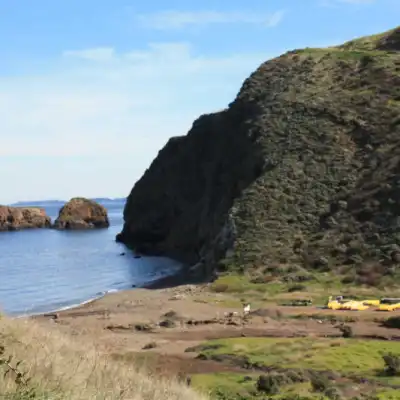 a rocky island in the middle of a body of water