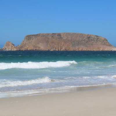 a beach with a mountain in the background