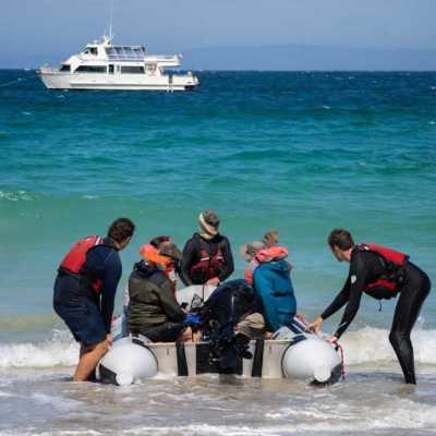 a group of people on a boat in the ocean