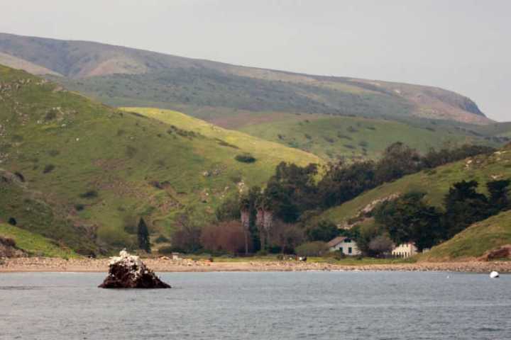 a body of water with a mountain in the background