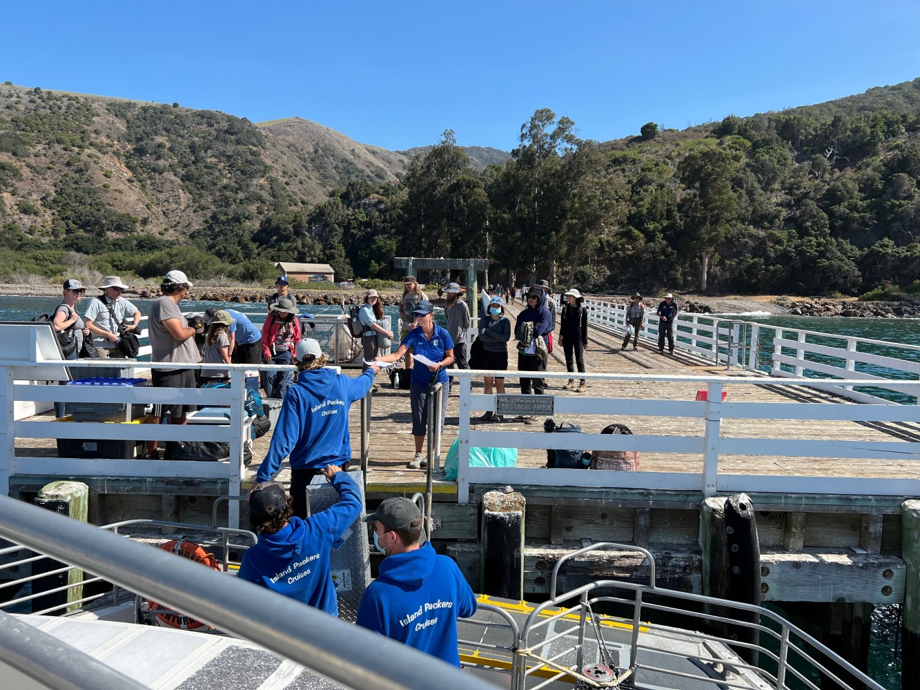 a group of people sitting at a dock