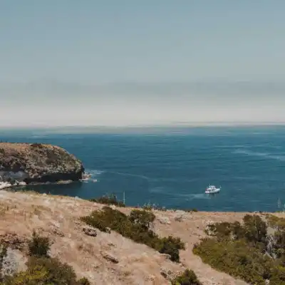 a rocky island in the middle of a body of water