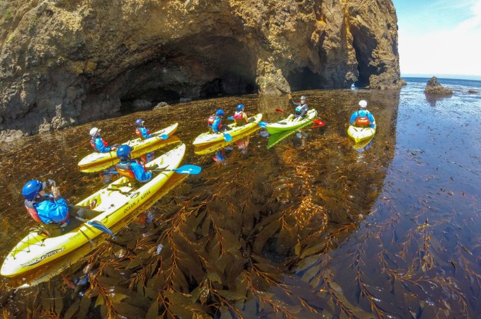 a raft next to a rock wall