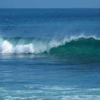 a man riding a wave on a surfboard in the ocean