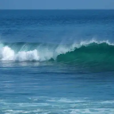 a man riding a wave on a surfboard in the ocean