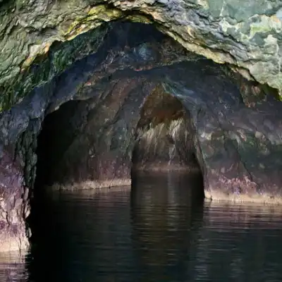 a cave next to a body of water