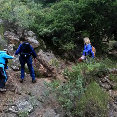 a group of people walking down a dirt trail