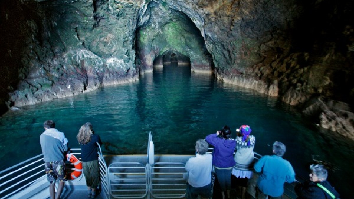 a group of people standing in front of a body of water