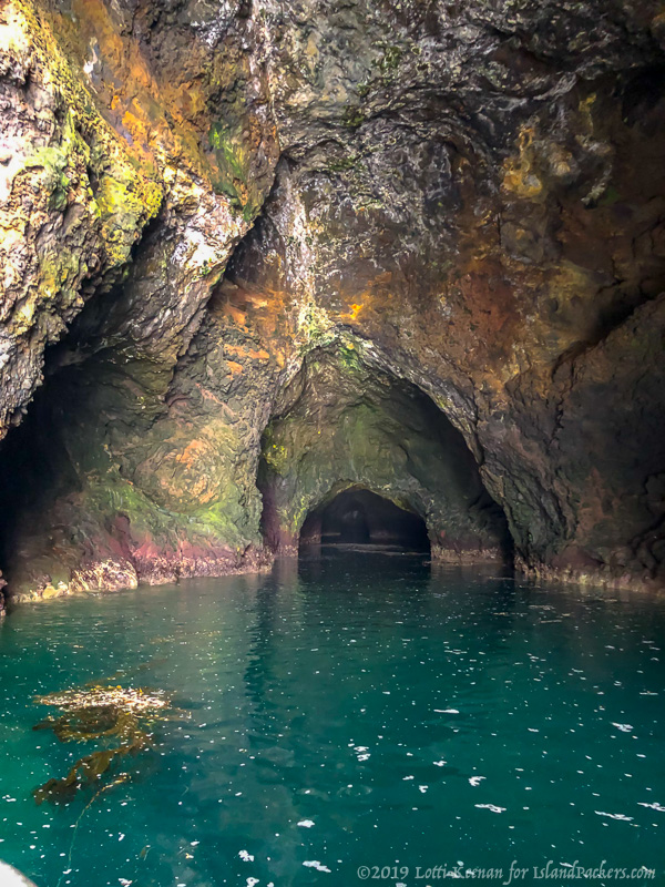 a large rock next to a body of water