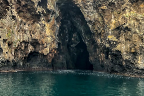 a large body of water with a mountain in the background