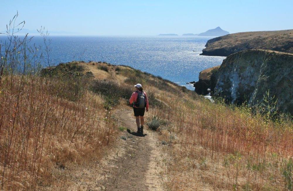 a man walking down a dirt road
